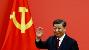 Xi Jinping in front of Chinese flag.
