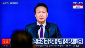A TV screen shows footage of South Korean President Yoon Suk Yeol's New Year's address