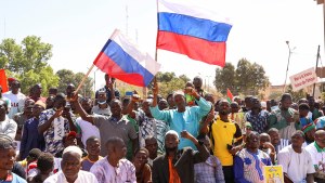 Men hold Russian flags as they gather to show their support to the Junta leader Ibrahim Traore and demand the departure of the French ambassador in Burkina Fas