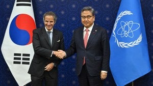 Rafael Grossi, director general of the International Atomic Energy Agency, shakes hands with South Korean Foreign Minister Park Jin