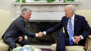 President Biden shakes hands with Jordan's King Abdullah II.