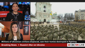 Screenshot of Lizzy Shackelford, Natasha Fatah, and Ukrainian soldiers in front of a monument on CBC News.