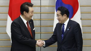 Yoon Suk Yeol, South Korea's president, left, and Fumio Kishida, Japan's prime minister, shake hands ahead