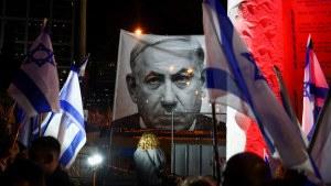 A large banner depicting Israeli Prime Minister Benjamin Netanyahu is seen during a demonstration against him in Tel Aviv