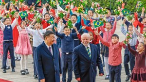 Lula and Xi walk outside near crowd of children