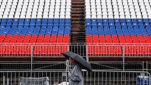 A man walks through Red Square on a rainy day in Moscow