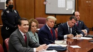Trump arraignment at table in court.