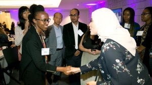 A member shakes hands with a speaker after an event
