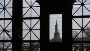 the Statue of Liberty seen through a window from Ellis Island