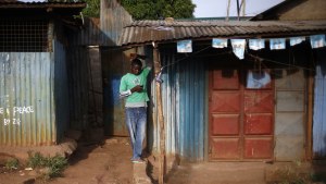 Man in Kenya reading his phone