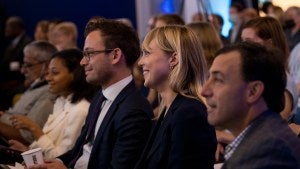 People in the audience smile during a Council event