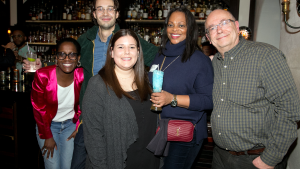 Five people stand together at a Council event