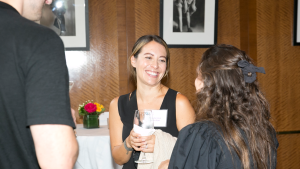 Two people laughing and talking at a Council event