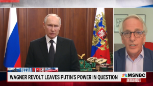 Screenshot of Ivo Daalder at right speaking on MSNBC next to footage of Putin at left. 