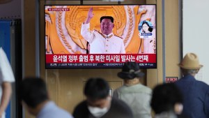  TV screen showing a news program reporting about North Korea's missile launch with a file footage of North Korean leader Kim Jong Un is seen at the Seoul Railway Station
