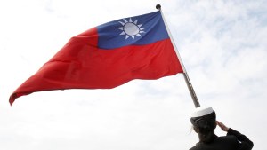 a servicemember waves a Taiwanese flag
