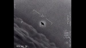 an unexplained object is seen at center as it is tracked as it soars high along the cloud