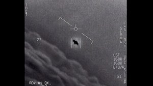 an unexplained object is seen at center as it is tracked as it soars high along the cloud