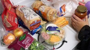 Jaqueline Benitez puts away groceries at her home in Bellflower, California.