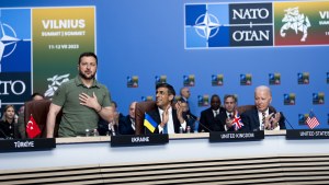 Zelenskyy stands at a table of NATO leaders