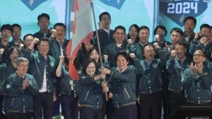 Taiwanese President Tsai Ing-wen, center left, hands over a flag to the party's presidential candidate William Lai during the party congress of the ruling Democratic Progressive Party