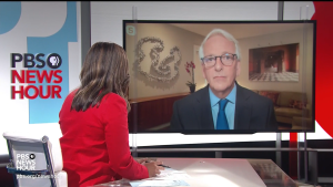 Screenshot of Amna Nawaz in red facing screen with Ivo Daalder on PBS NewsHour