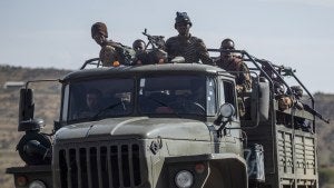 Ethiopian government soldiers ride in the back of a truck on a road in the Tigray region 