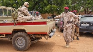 Nigerien national guardsmen sit outside the customs offices in Niamey