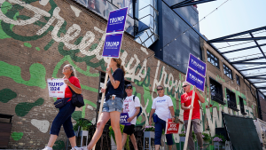 Trump supporters walk near the Fiserv Forum ahead of the first Republican debate of the 2024 election. 