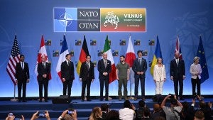 Biden stands on a stage with fellow NATO leaders