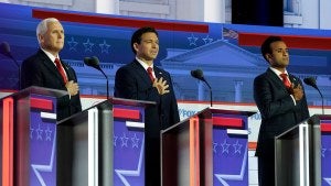 Mike Pence, Ron DeSantis and Vivek Ramaswamy stand on stage