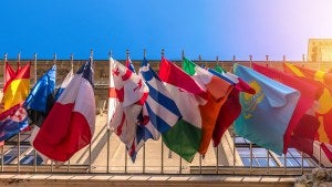 International flags hanging on a building.