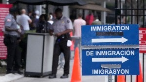 Officers stand outside the Immigration and Customs Enforcement (ICE) office