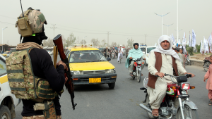 A Taliban fighter stands in the road during a celebration marking the second anniversary of the withdrawal of US troops from Afghanistan