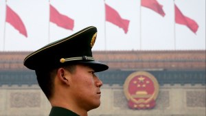 A Chinese paramilitary policeman stands guard near the Great Hall of the People in Beijing