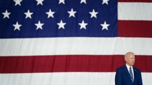 Joe Biden stands in front of an American flag