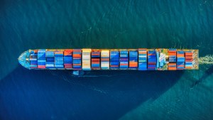 An aerial view of a ship carrying shipping containers