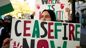 A woman holds a "Ceasefire Now," sign during a pro-Palestinian rally and march, Saturday, Oct. 28, 2023, in Seattle.