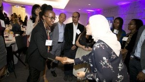 Audience member shakes hands with speaker.