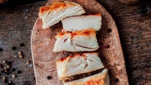 plant-based chicken fillet on a wooden platter