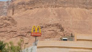 a McDonald's sign with a rocky landscape in the background