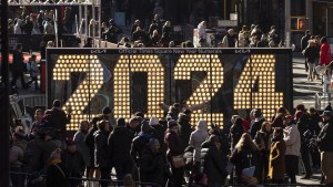 People gather around the 2024 New Year's Eve numerals displayed in Times Square, Wednesday, Dec. 20, 2023, in New York.