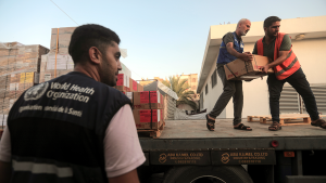 Palestinians unload boxes of medicine from a truck arrived at Nasser Medical Complex in Khan Younis, southern Gaza Strip, on October 23, 2023.