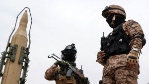 Iran's Revolutionary Guard members stand in front of Shahab-3 missile