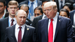 Former US President Donald Trump and Russian President Vladimir Putin talk during the family photo session at the APEC Summit on November 11, 2017.