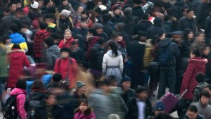 People rush to catch their train in Beijing to return home for the Chinese lunar new year