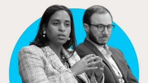 Black and white image of a person talking and someone listening next to them