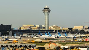 An exterior view of O'Hare airport with airplanes lined up along the runway