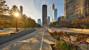 A bike path in downtown Chicago, with the sunrise to the left