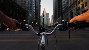 Tall buildings in Chicago behind bike handlebars